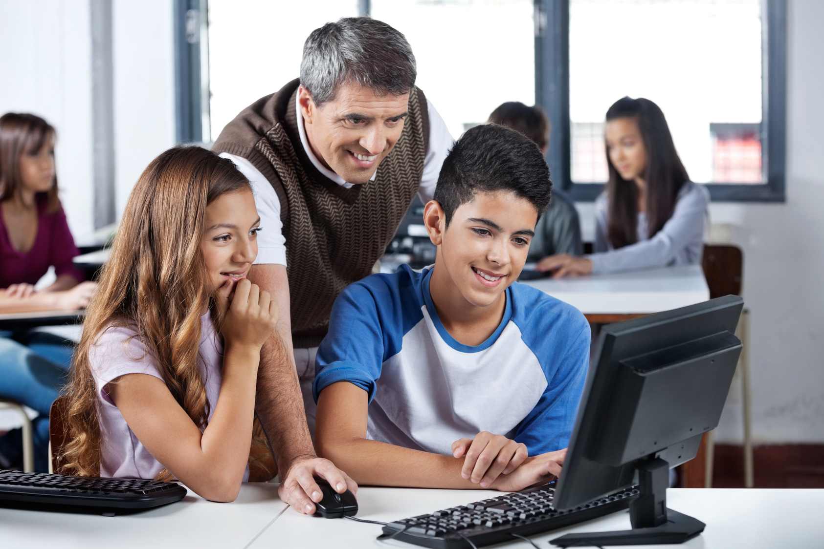 Mature Teacher and Students Using Computer